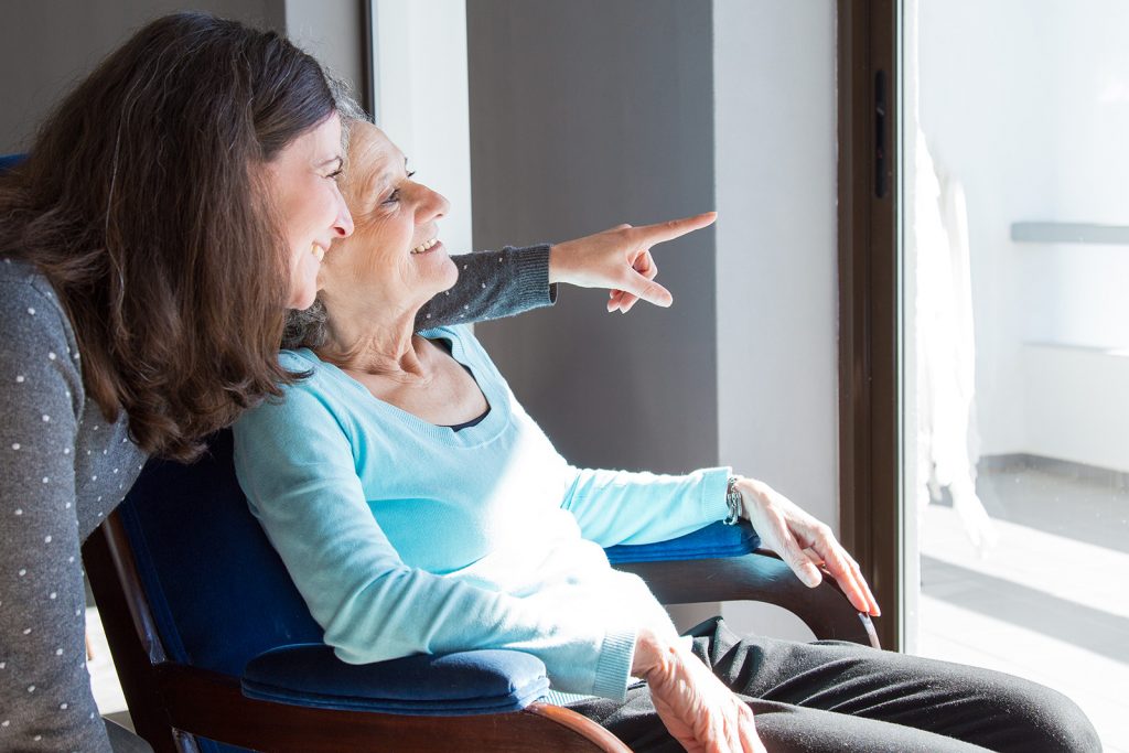 Mother and daughter share a view of the outside.