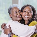 Senior woman, adult daughter hugging