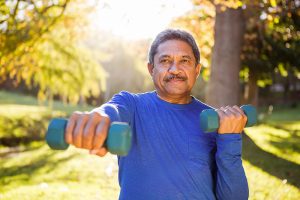 Older man exercising with dumbbells