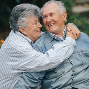 Senior couple hugging in a park