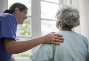 Nurse taking care of an older woman.