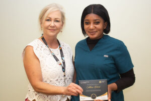 CEO Carey Lucki presents Allison with her Champions of Care award.