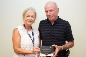 CEO Carey Lucki presents David with his Champions of Care award.