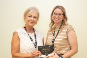 CEO Carey Lucki presents Michelle with her Champions of Care award.