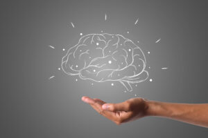 "Brain illustration in chalk, hand underneath"