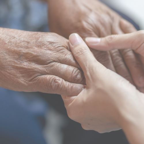 "Close up two people's hands holding for support"