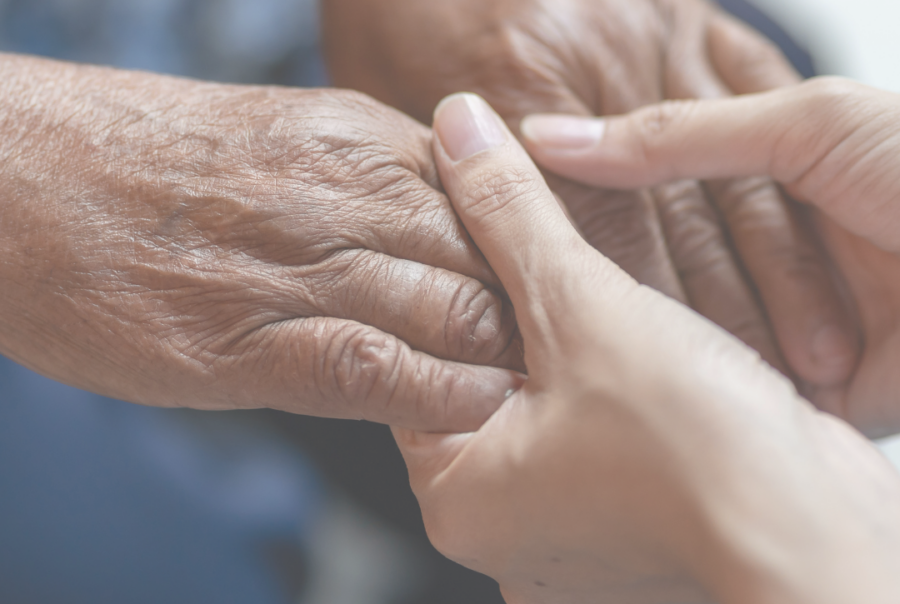 "Close up two people's hands holding for support"