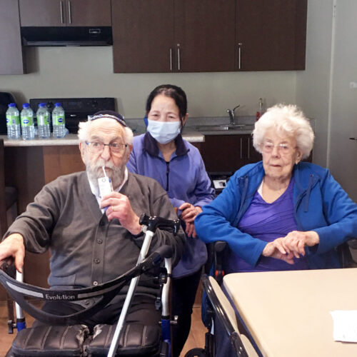 "Two seniors sitting with nurse after vaccination"