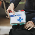 "Close up of senior woman holding first aid kit"