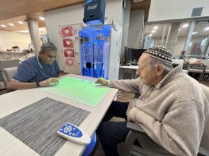 Two clients interact with the OMI projector