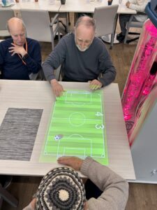 Clients playing a came of soccer on the OMI projector