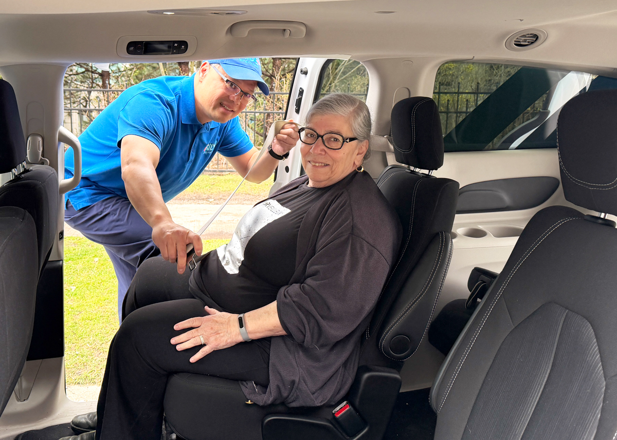 client in vehicle with driver putting on seatbelt