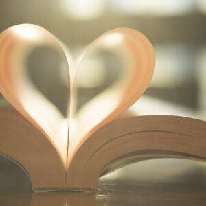 "heart shaped pages in a book under sunlight"