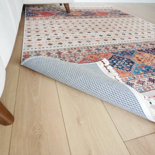 "throw rug curled on wooden floor"