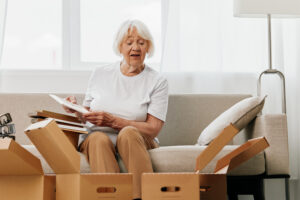"senior woman clean and sort boxes"