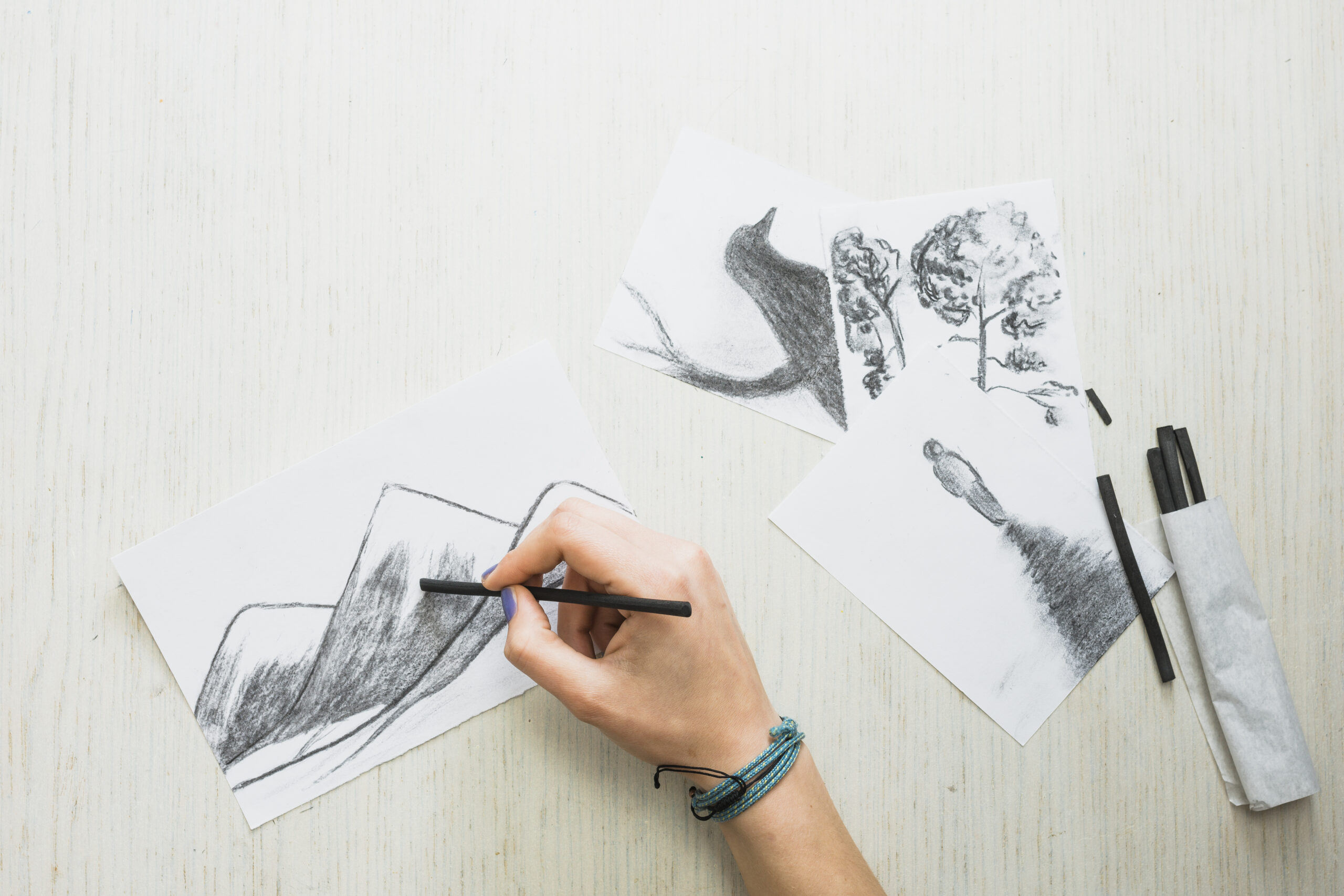 "hand sketching black drawing on white paper"